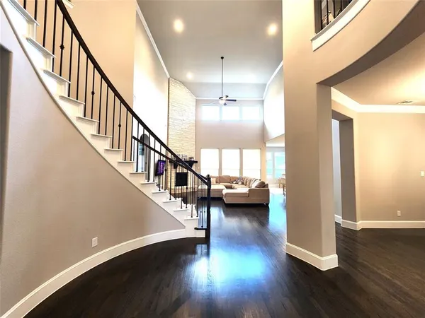 a view of entryway and hall with wooden floor