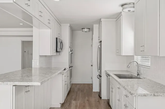 a kitchen with a sink stove and refrigerator