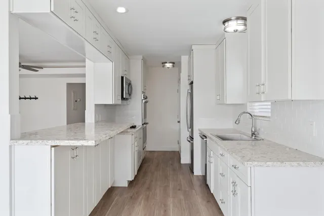 a kitchen with a sink stove and cabinets