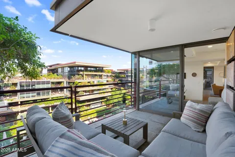 a living room with furniture and a view of balcony