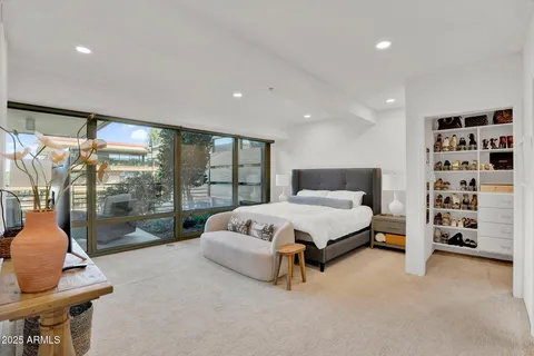 a spacious bedroom with a bed and a walk in closet