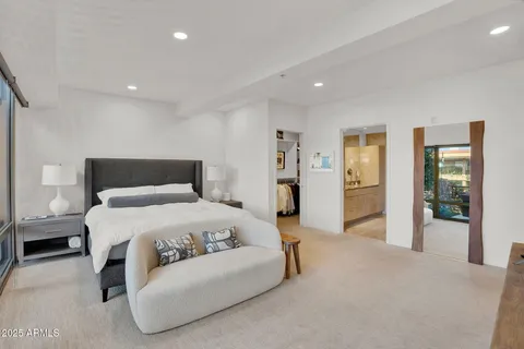 a bedroom with a large bed and walk in closet