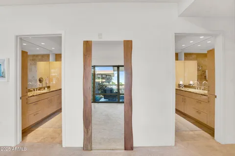 a view of a hallway with dining room and refrigerator