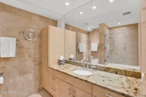 a bathroom with a granite countertop sink mirror and double