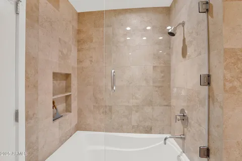 a bathroom with a bathtub and shower