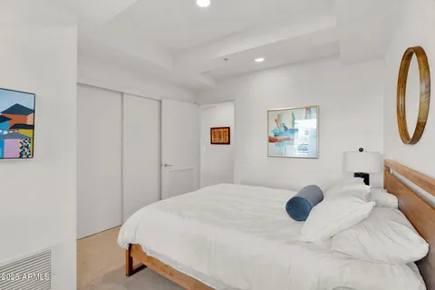 a bedroom with a bed and a cabinets