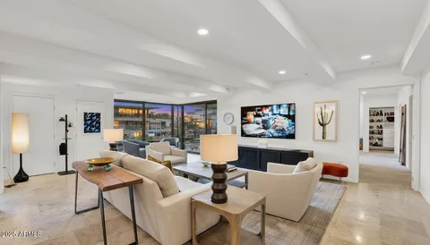 a living room with furniture and painting on the wall