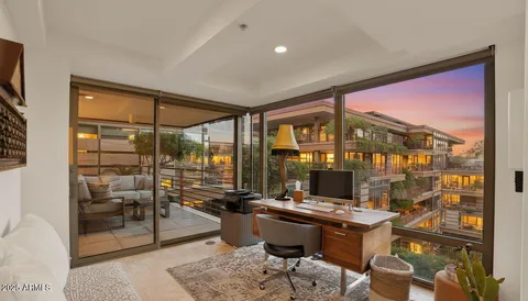 a room with furniture water view and large windows