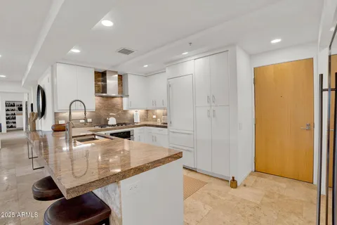 a kitchen with granite countertop a sink and a counter space