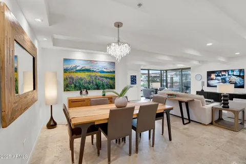 a view of a dining room with furniture and chandelier