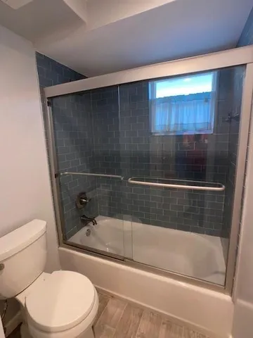 a bathroom with a toilet and a bathtub