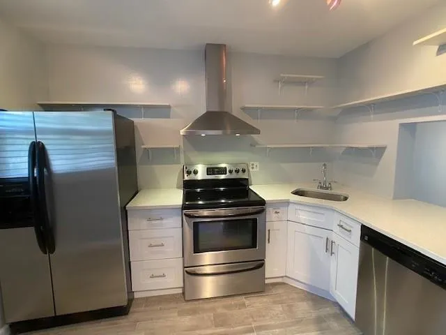 a kitchen with stainless steel appliances and white cabinets