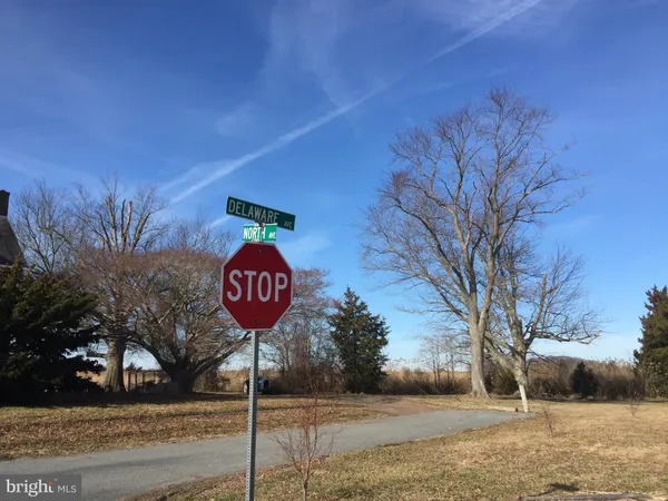 a view of a street with a yard