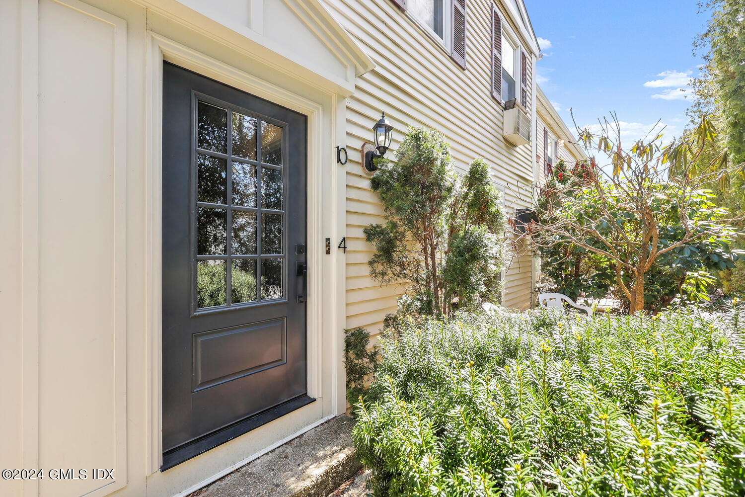 9 Weaver Street, Unit 4 Greenwich, CT 06831 - Photo 1 of 30 a view of a door and chair in front of statue