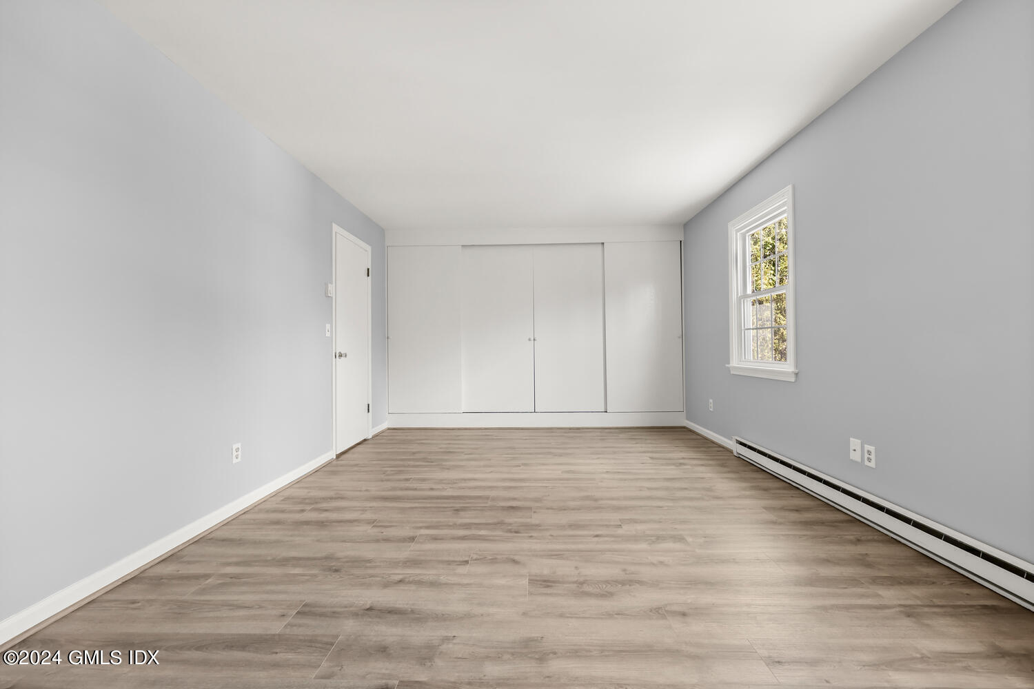 9 Weaver Street, Unit 4 Greenwich, CT 06831 - Photo 16 of 30 a view of an empty room with window and wooden floor
