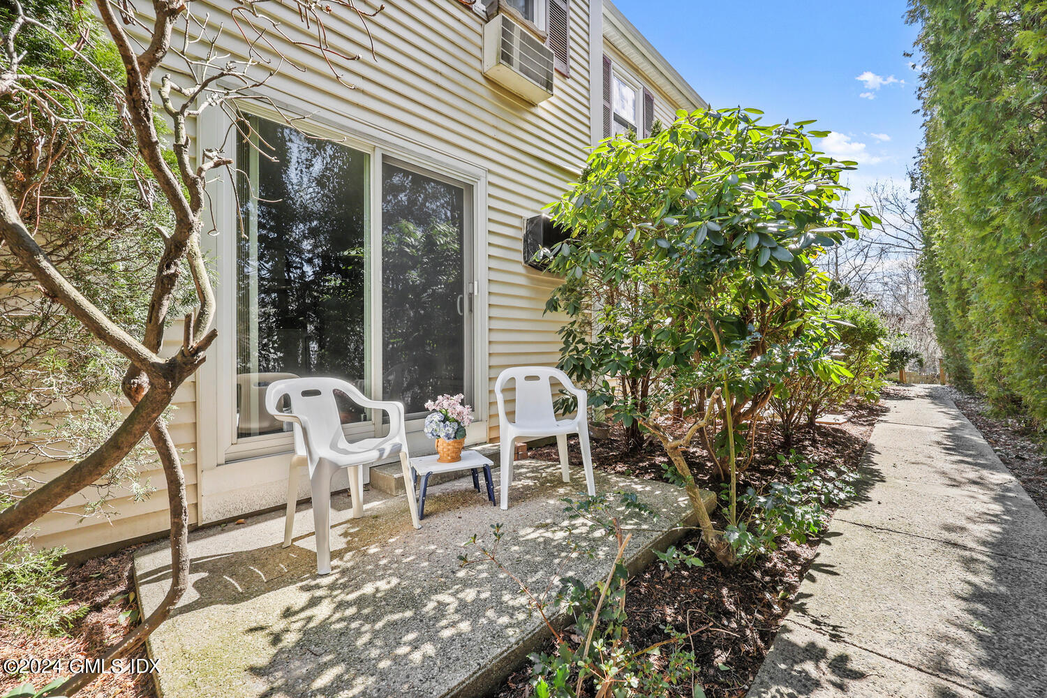 9 Weaver Street, Unit 4 Greenwich, CT 06831 - Photo 21 of 30 a view of a chair and tables in the patio