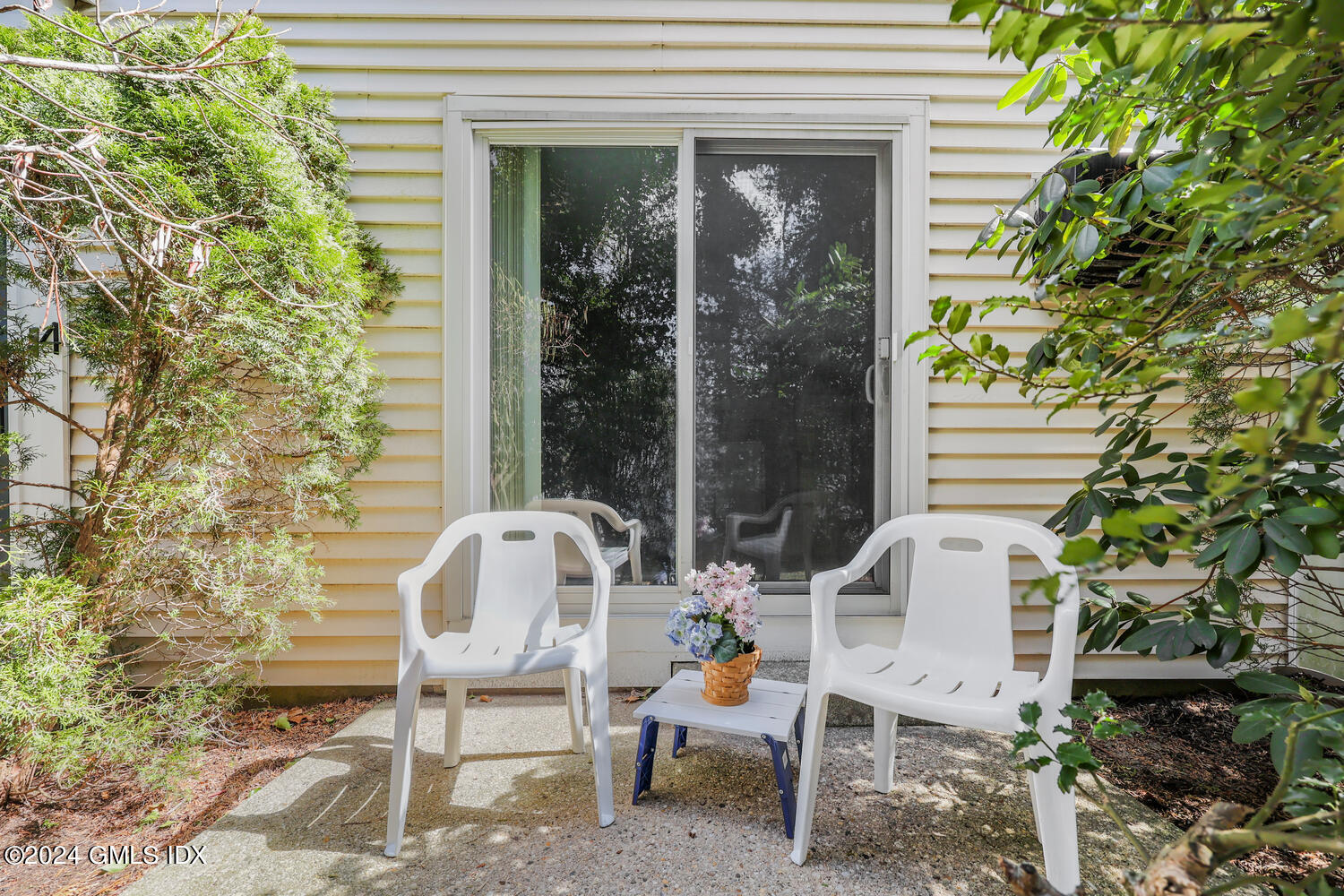9 Weaver Street, Unit 4 Greenwich, CT 06831 - Photo 23 of 30 a balcony with table and chairs and potted plants