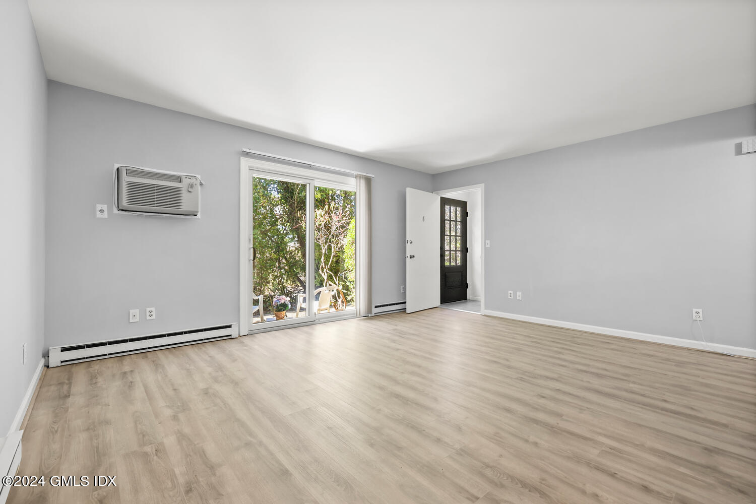 9 Weaver Street, Unit 4 Greenwich, CT 06831 - Photo 3 of 30 a view of an empty room with wooden floor and a window