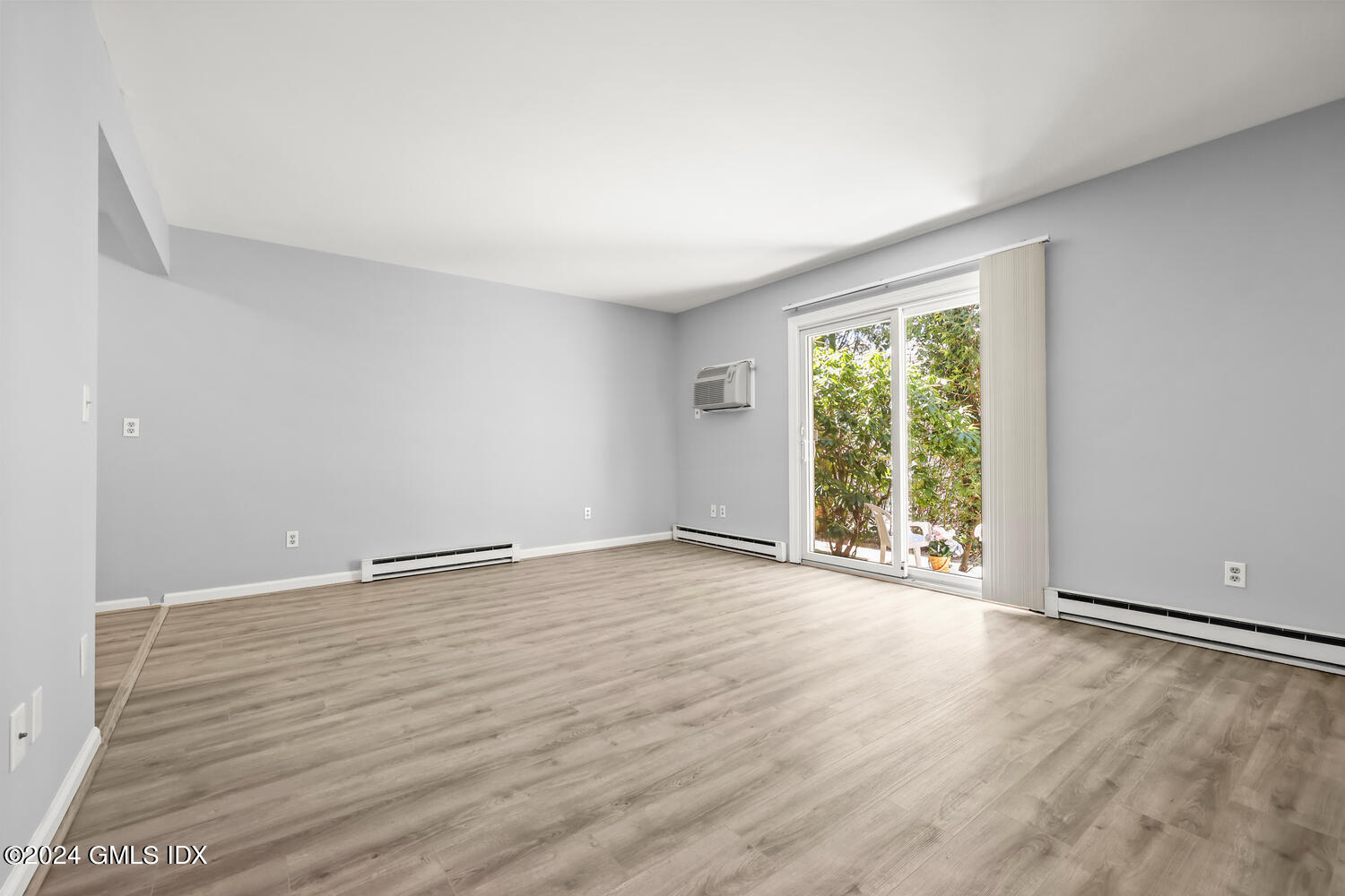 9 Weaver Street, Unit 4 Greenwich, CT 06831 - Photo 4 of 30 wooden floor in an empty room with a window