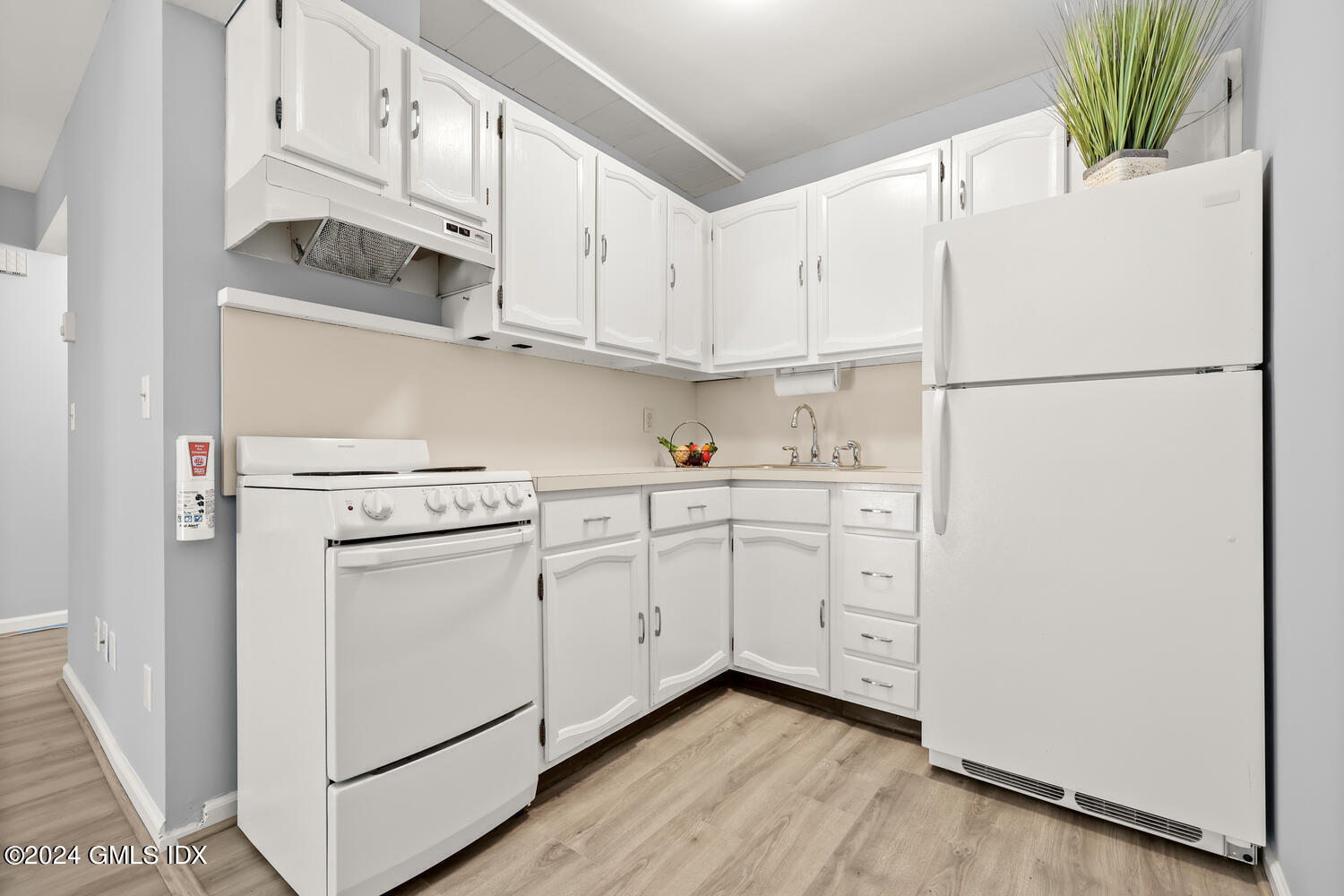 9 Weaver Street, Unit 4 Greenwich, CT 06831 - Photo 9 of 30 a kitchen with white cabinets and white appliances