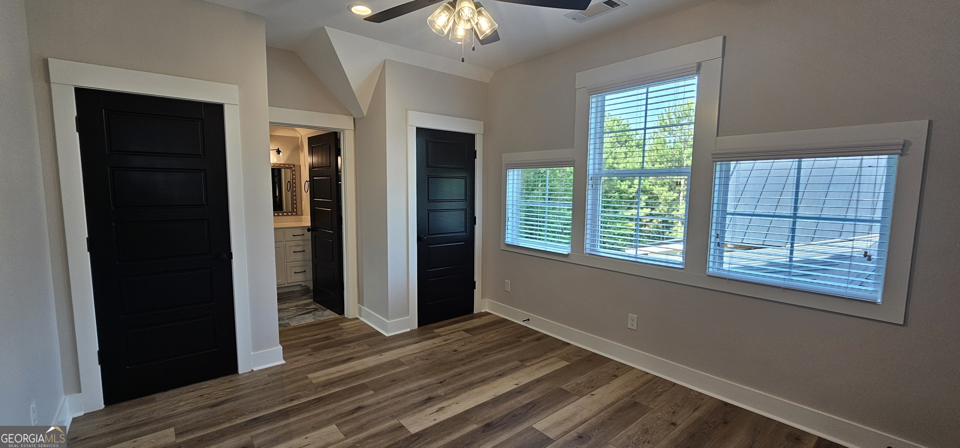 654 Liberty Hill Road Milner, GA 30257 - Photo 102 of 180 a view of an empty room with wooden floor and a window