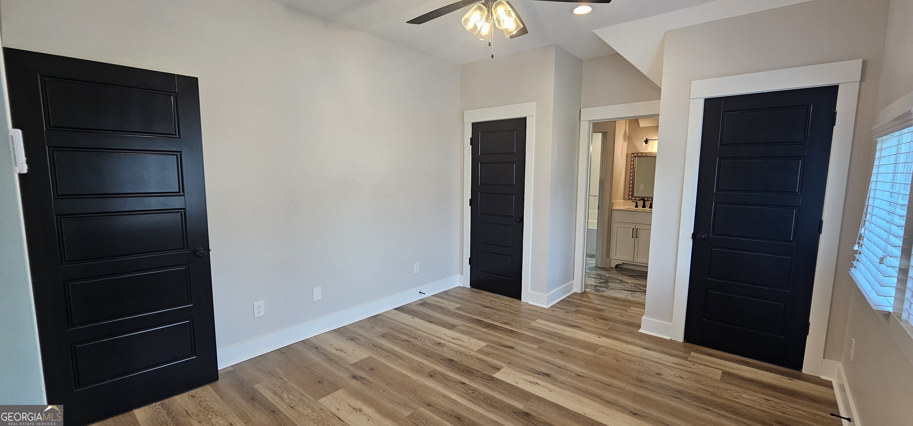 654 Liberty Hill Road Milner, GA 30257 - Photo 103 of 180 a view of an empty room with wooden floor and closet