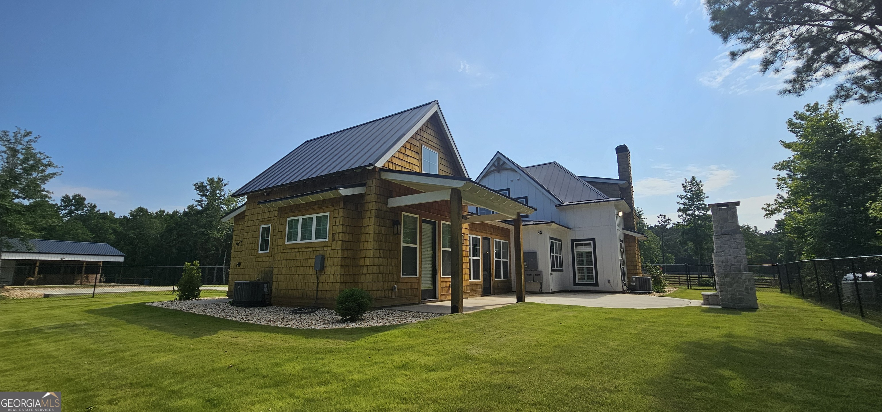 654 Liberty Hill Road Milner, GA 30257 - Photo 12 of 180 a view of a house with a yard and sitting area
