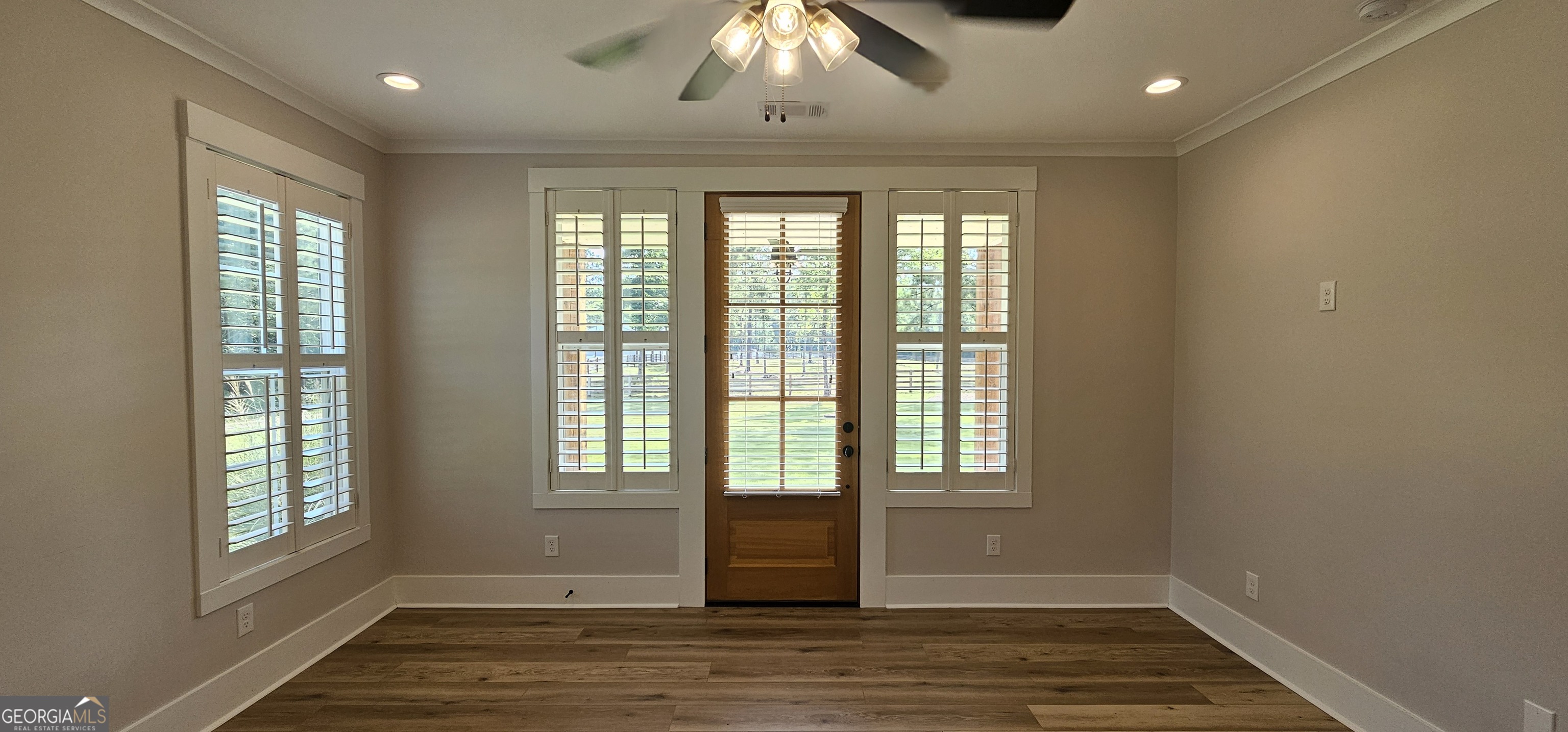 654 Liberty Hill Road Milner, GA 30257 - Photo 145 of 180 a view of an empty room with wooden floor and a window