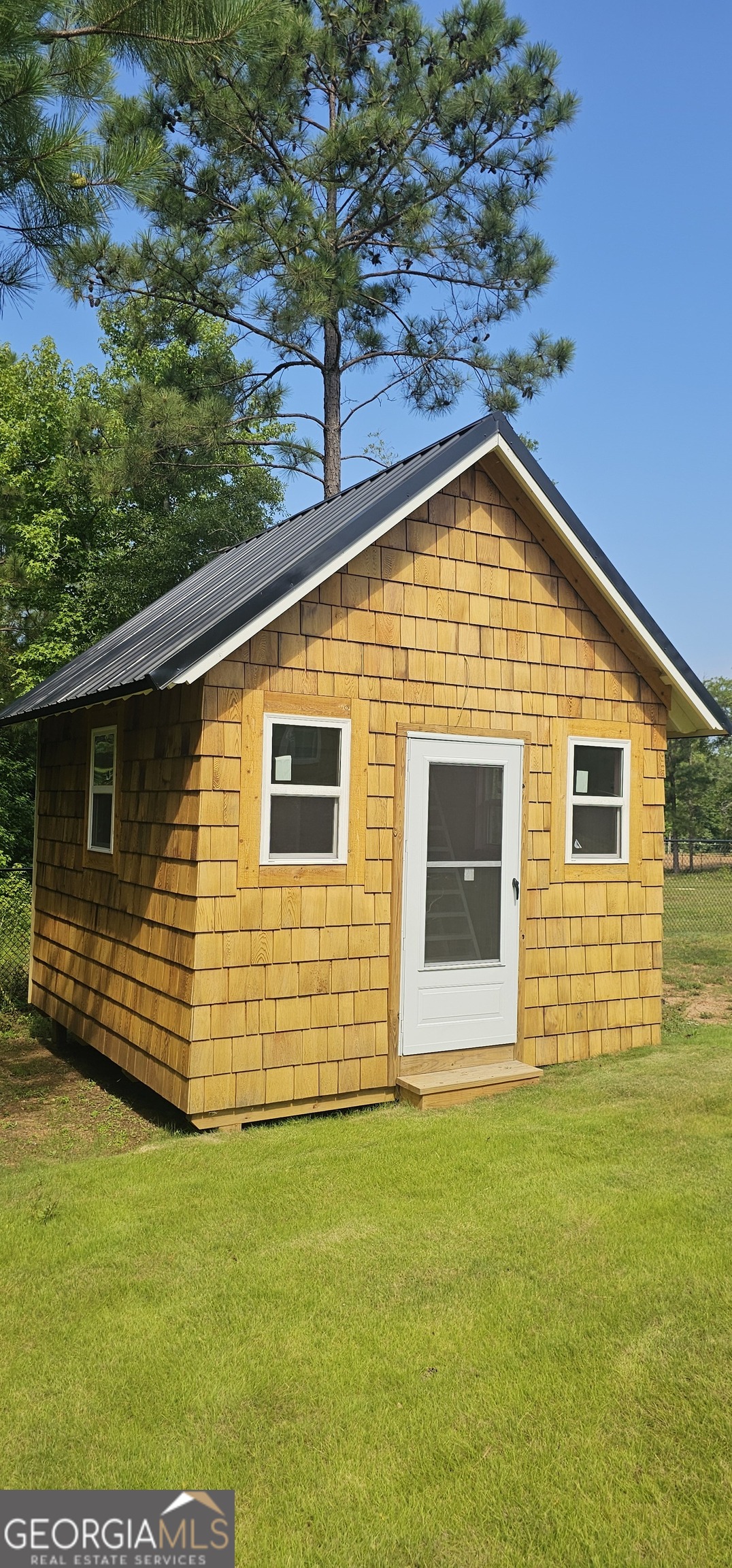 654 Liberty Hill Road Milner, GA 30257 - Photo 17 of 180 a front view of a house with a garden