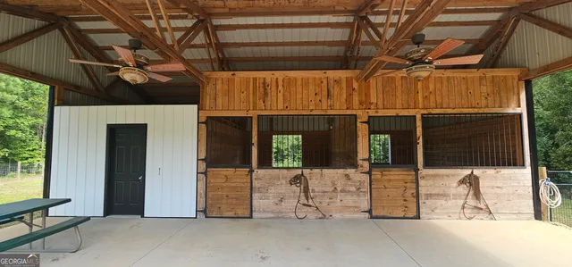 a view of a room with wooden floor and windows