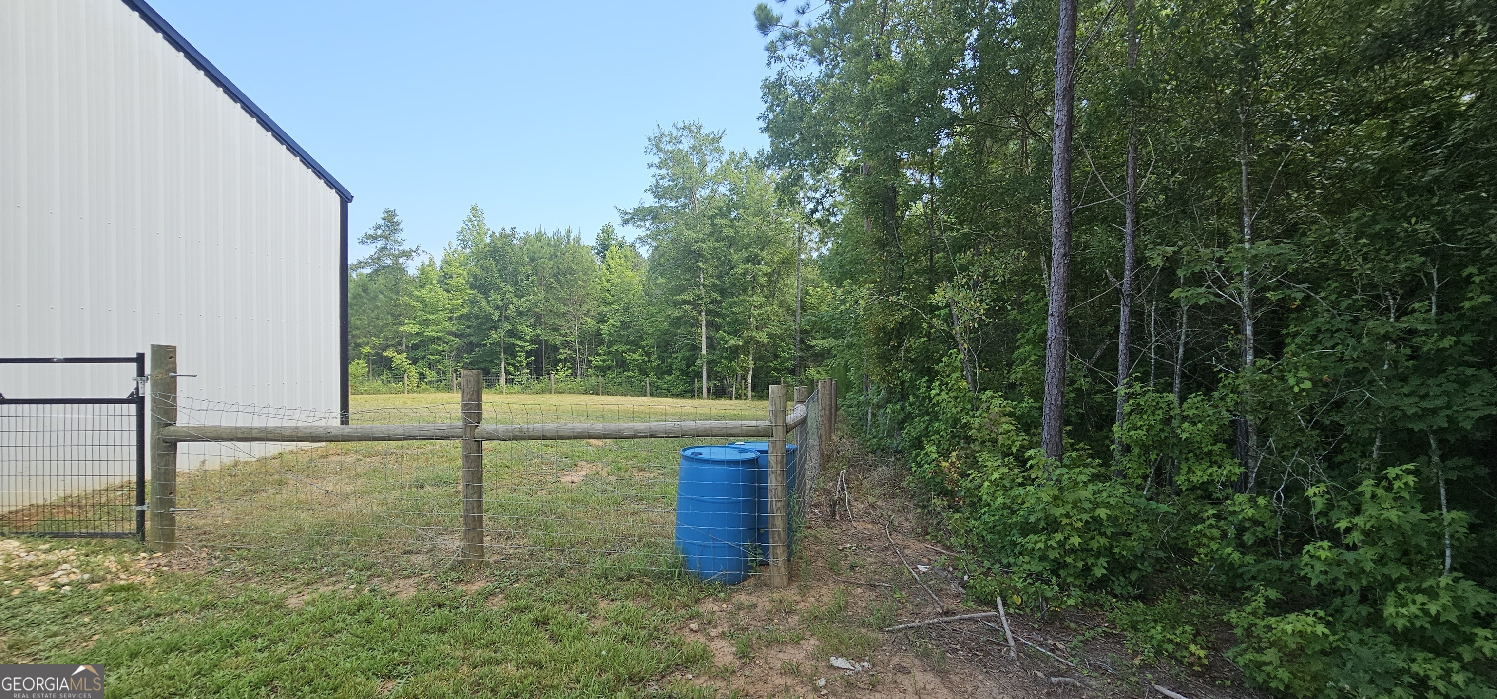 654 Liberty Hill Road Milner, GA 30257 - Photo 45 of 180 a view of a backyard with large trees