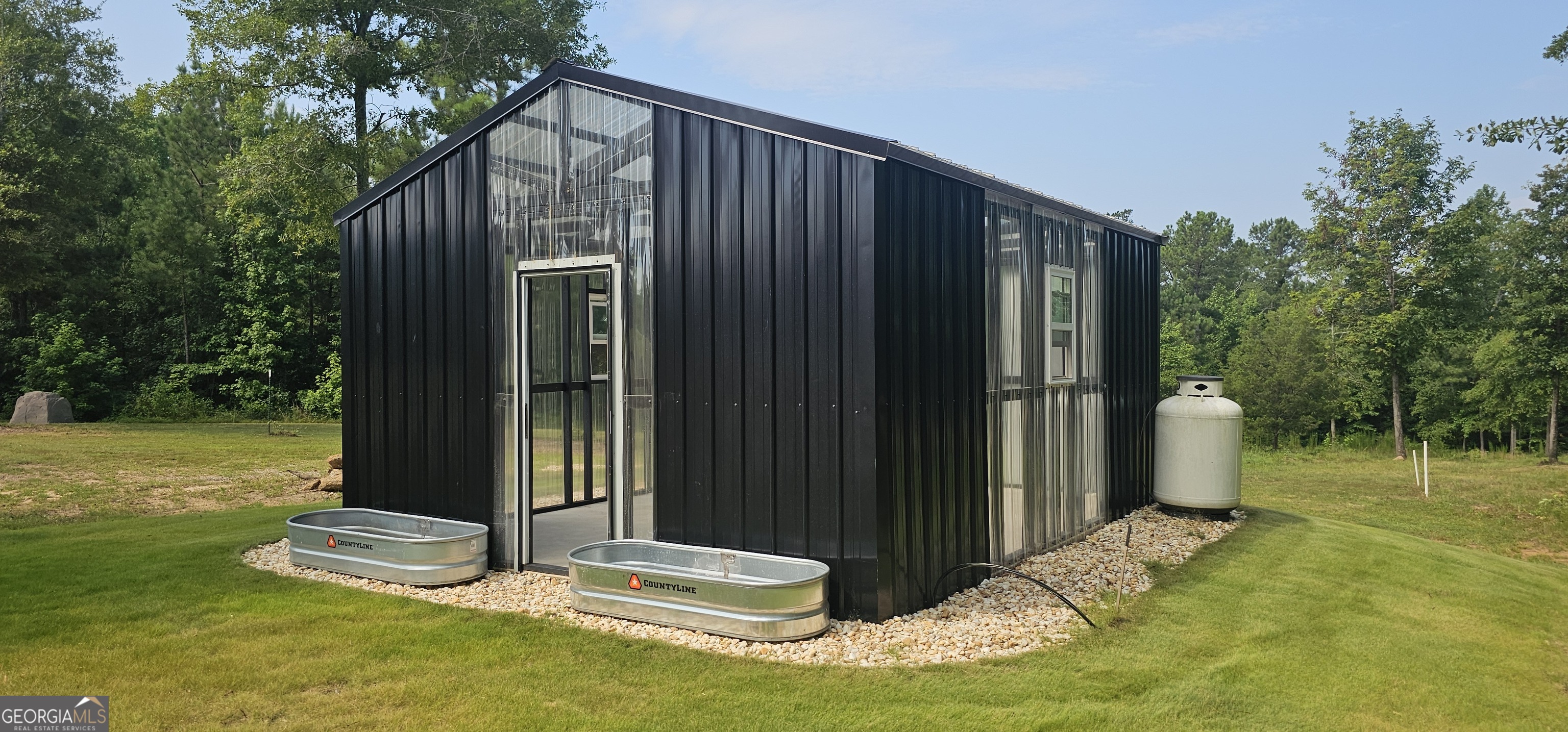 654 Liberty Hill Road Milner, GA 30257 - Photo 51 of 180 a backyard of a house with table and chairs