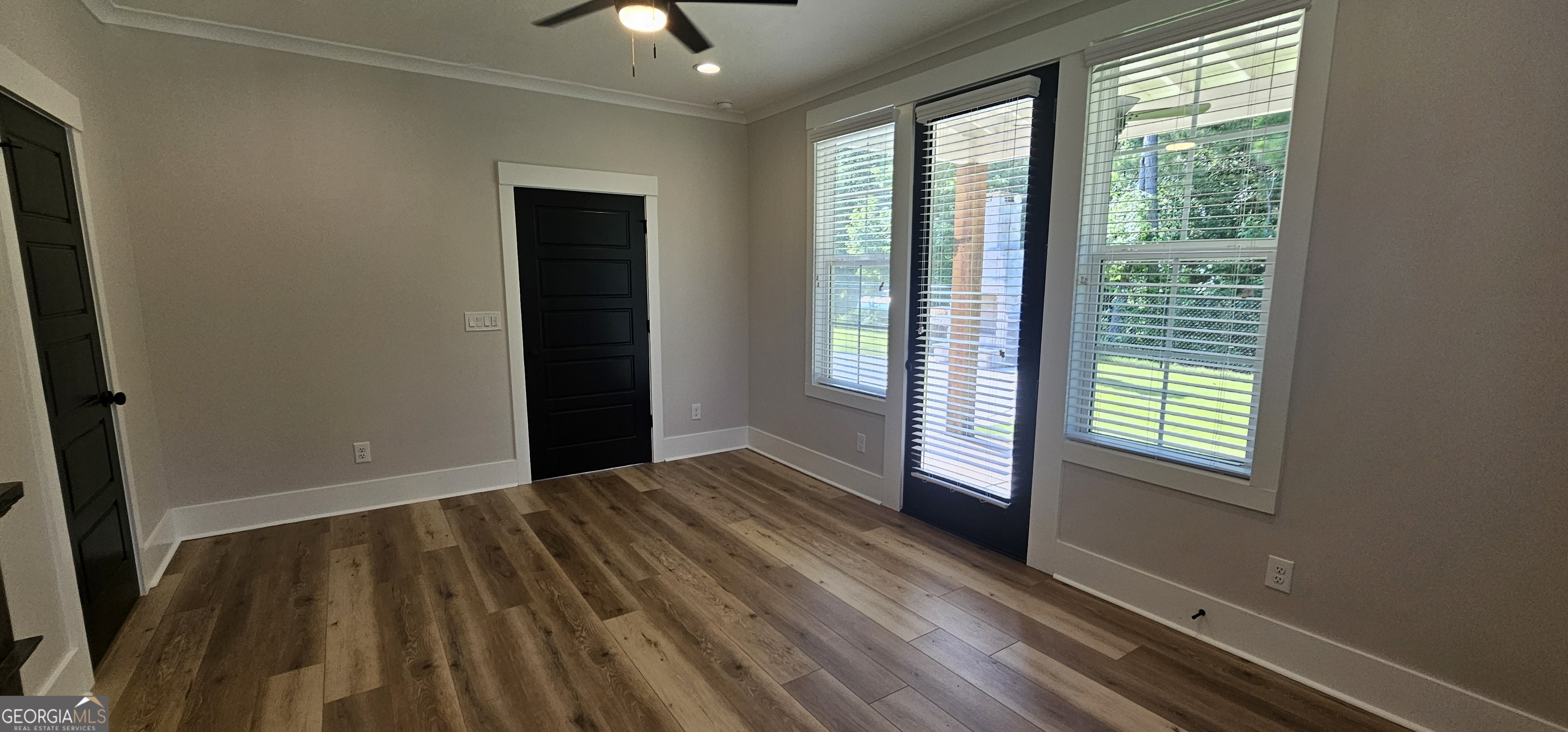 654 Liberty Hill Road Milner, GA 30257 - Photo 63 of 180 a view of an empty room with wooden floor and a window