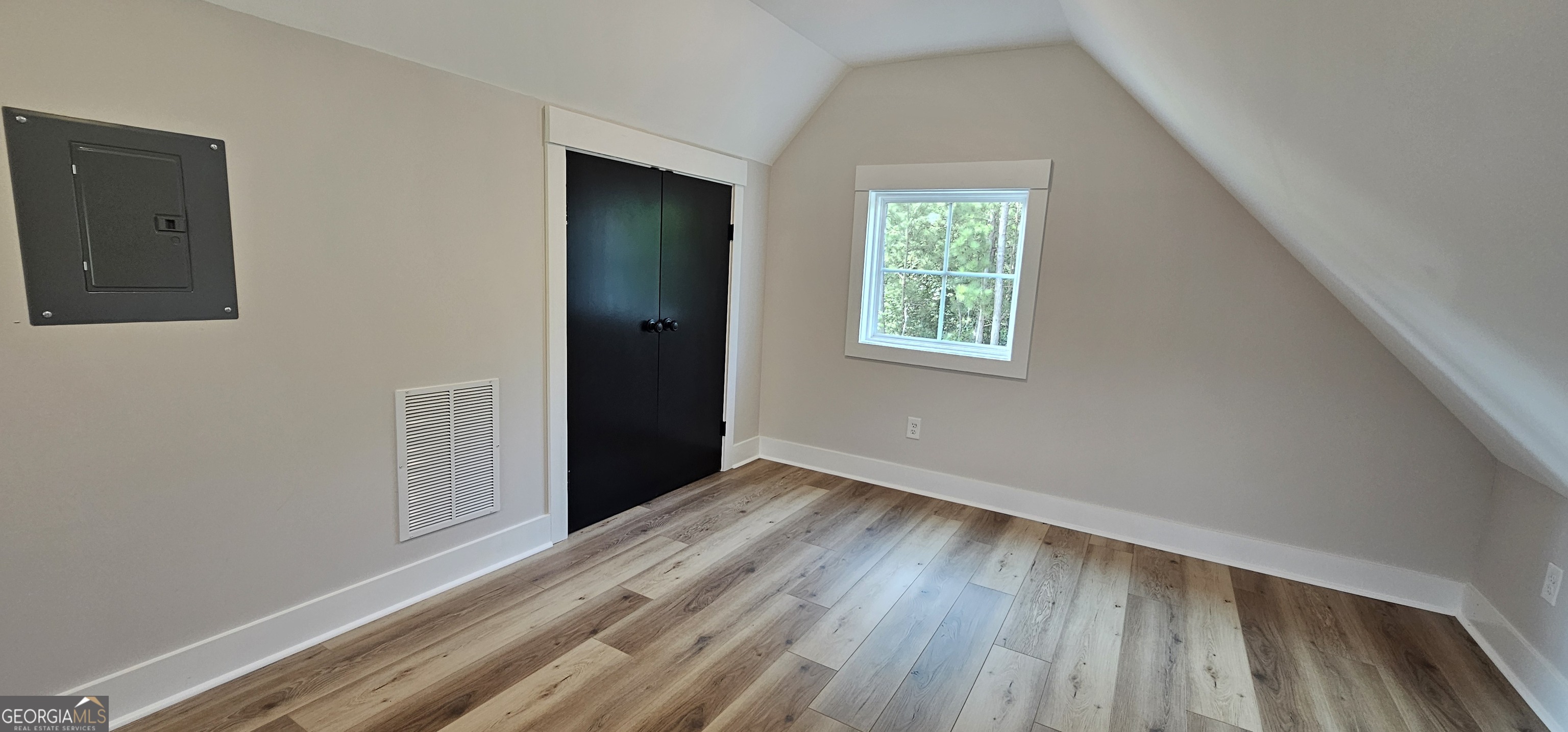 654 Liberty Hill Road Milner, GA 30257 - Photo 74 of 180 an empty room with wooden floor and windows