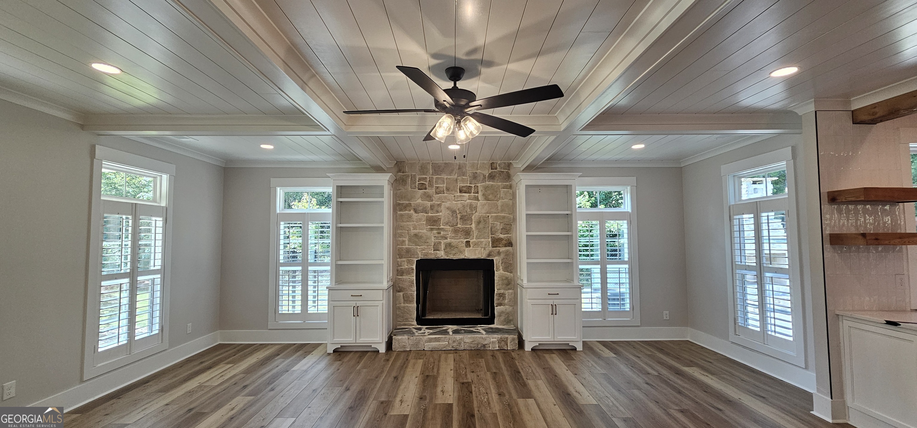 654 Liberty Hill Road Milner, GA 30257 - Photo 95 of 180 a view of a livingroom with a fireplace window hardwood floor and a ceiling fan