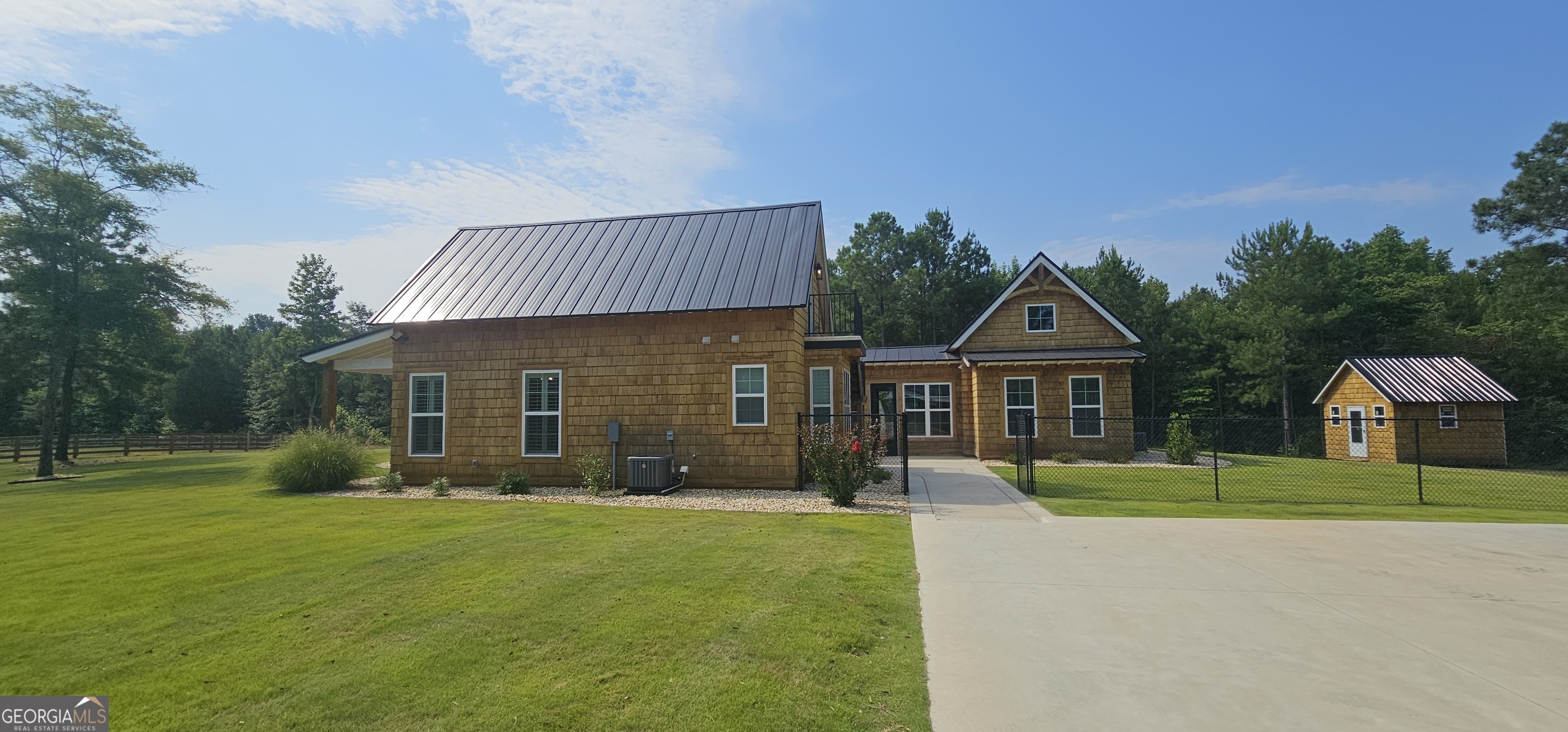 654 Liberty Hill Road Milner, GA 30257 - Photo 10 of 180 a front view of a house with a yard and trees