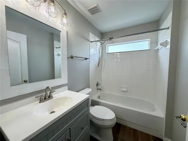 a bathroom with a sink a toilet and a bathtub