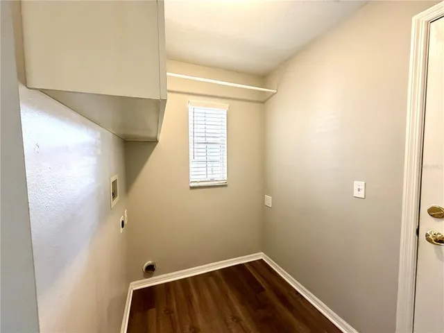 a small space with wooden floor and a window