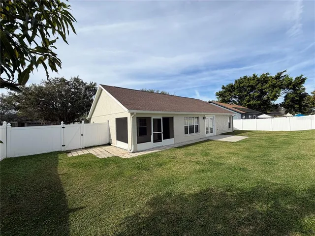 a view of a house with a backyard