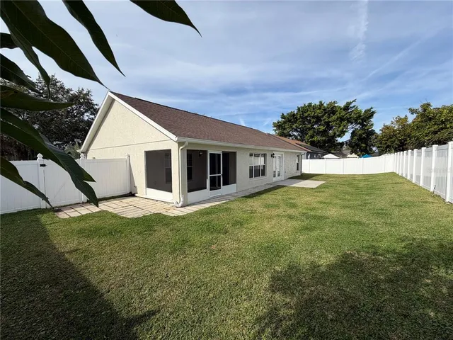 a view of a house with a yard and garage