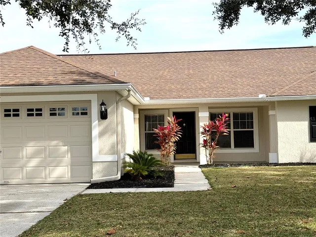 a view of a house with potted plants