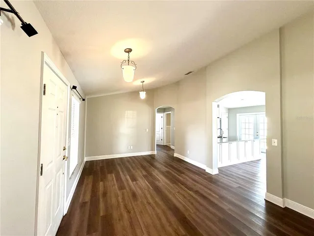 a view of a room with wooden floor
