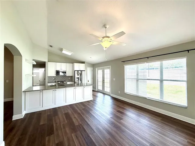 a large kitchen with kitchen island a large counter space a sink and appliances