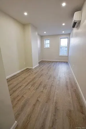an empty room with windows and closet