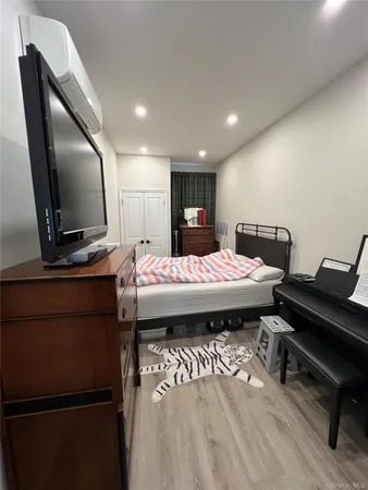 a bed room with a bed and a television