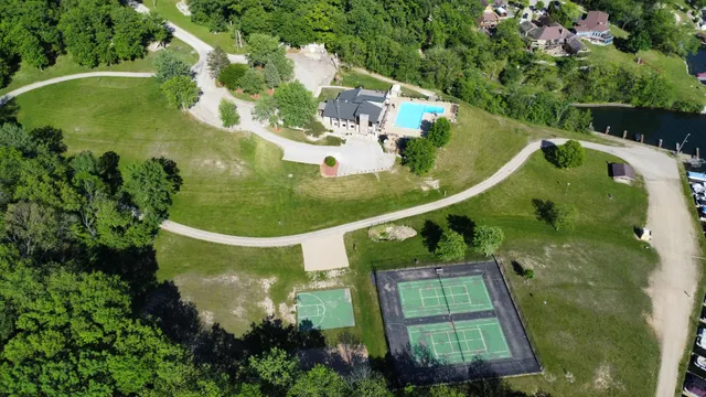 an aerial view of a house with yard swimming pool and outdoor seating