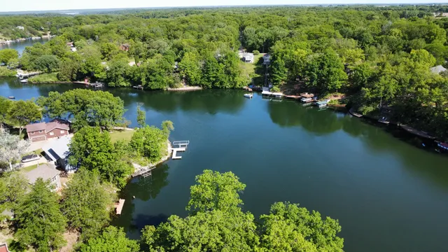 an aerial view of a house with swimming pool outdoor seating and yard