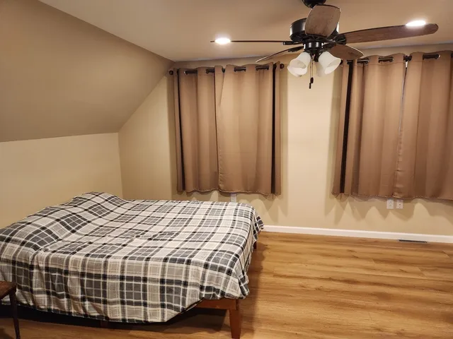 a bedroom with a bed and a mirror