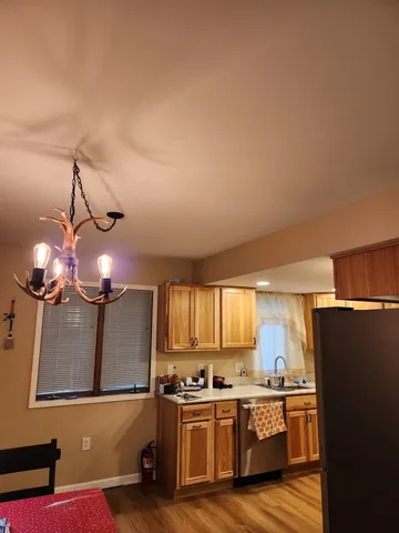 a kitchen with stainless steel appliances granite countertop a sink a stove and refrigerator