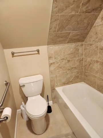 a bathroom with a toilet and bathtub